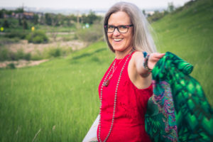 beth smiling in a field with a shawl